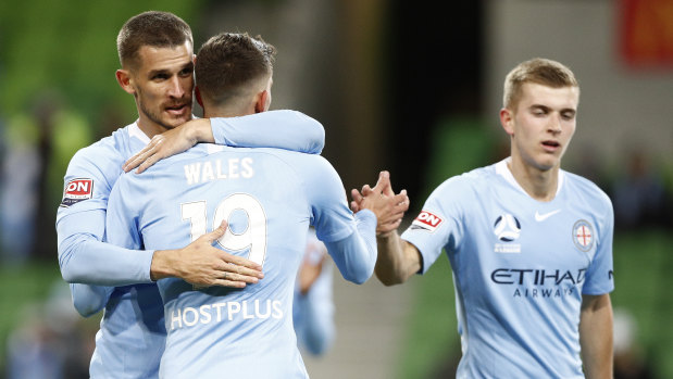 Dario Vidosic (left) and Lachlan Wales celebrate a goal against the Mariners on Friday night.