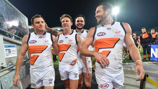 Heath Shaw (left) walks off a winner in his 300th AFL game after the Giants' one-point win over Port Adelaide on Saturday night, which has put GWS back in top-four contention.