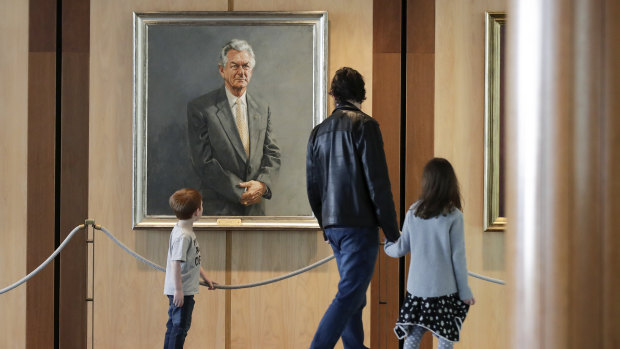 Brisbane's Bernard Macnaught and his children Thomas and Victoria view former prime minister Bob Hawke's portrait during their visit to Parliament House last week.  