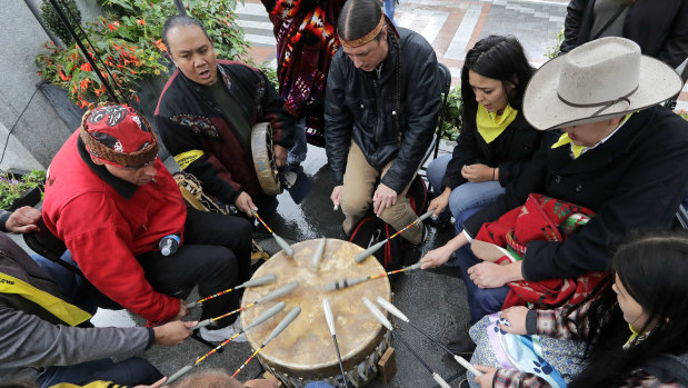 Native Americans and First Nations people join in on a drum circle during an Indigenous Peoples Day blessing and rally before a march in Seattle.
