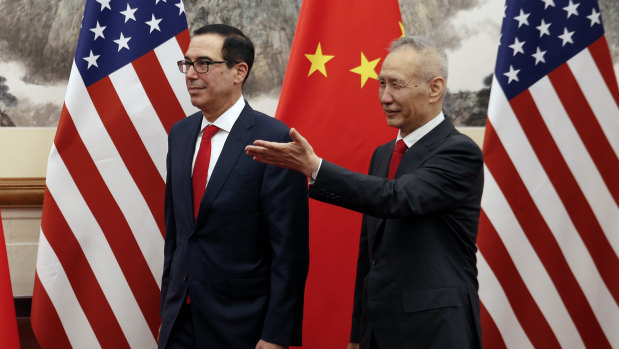 Chinese Vice-Premier Liu He shows the way to US Treasury Secretary Steven Mnuchin during their meeting at the Diaoyutai State Guesthouse in Beijing.
