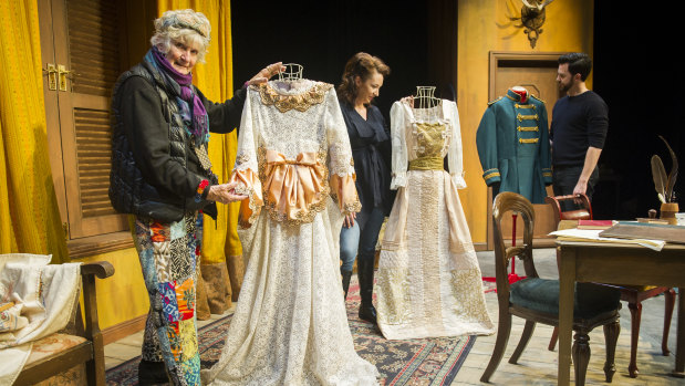 Arms and the Man costumer designer Anna Senior with the play's lead actors Lexi Sekuless and Joel Hutchings. The dress on the right started life as a doona.