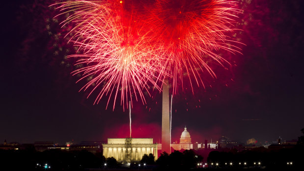 Fourth of July fireworks explode over Lincoln Memorial, Washington Monument and US Capitol, along the National Mall in Washington.