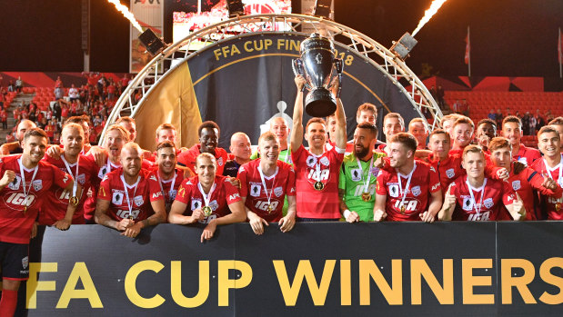 Adelaide United players celebrate after winning the FFA Cup final match against Sydney FC.
