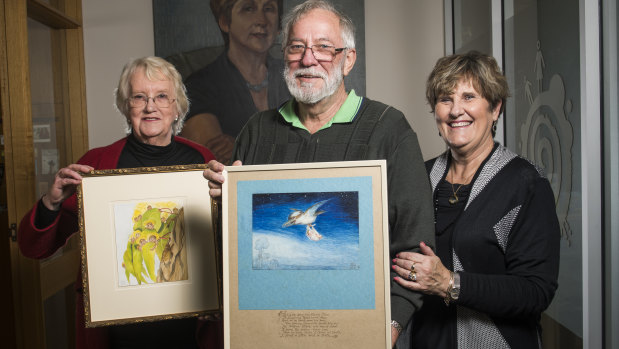 Jane Brummitt, left, and Geoff and Amanda Turville with their rare paintings. 