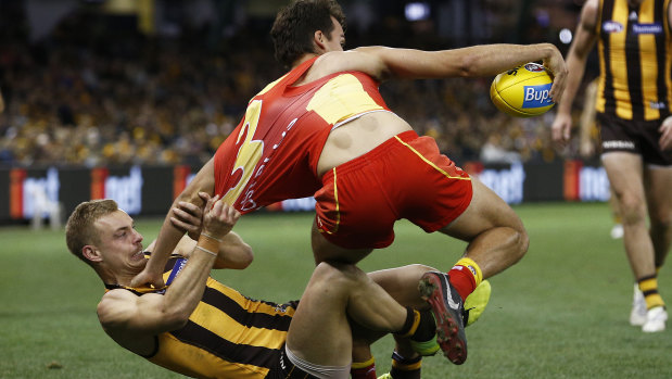 Gritty defence: Hawk James Worpel brings down Gold Coast's Jack Bowes.
