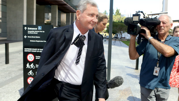 Wayne Myers leaves court on Thursday afternoon surrounded by a media scrum.