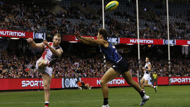 Forward march: Saint Callum Wilkie kicks clear over Charlie Curnow of the Blues.