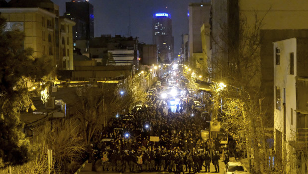 Iranian police officers take position while protesters gather in front of Amir Kabir University in Tehran, Iran.