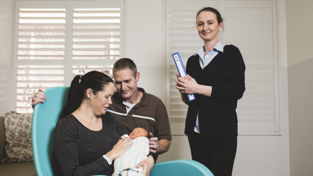 Queanbeyan couple Emma Weston and Mick Campbell with their newborn son William in one of the new single rooms in  the revamped maternity ward at Calvary Public Hospital. With them is midwife Helen Stephenson.