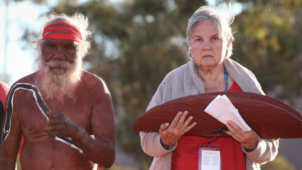 Mutitjulu elder Rolley Mintuma and Pat Anderson from the Referendum Council with a piti holding the Uluru Statement from the Heart last year. 