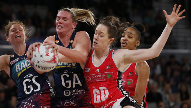 Up for grabs: Melbourne's Caitlin Thwaites contests possession with Chelsea Blackman of the Thunderbirds.