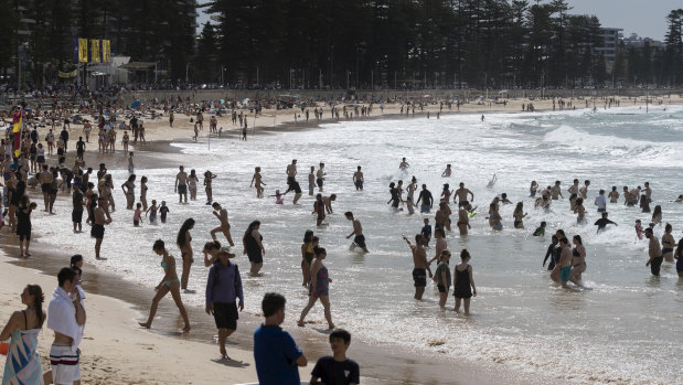 Swimmers flock to the beach at Manly on the first 30-degree day of spring.