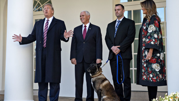 President Donald Trump, left, speaks while introducing Conan, the military service dog.