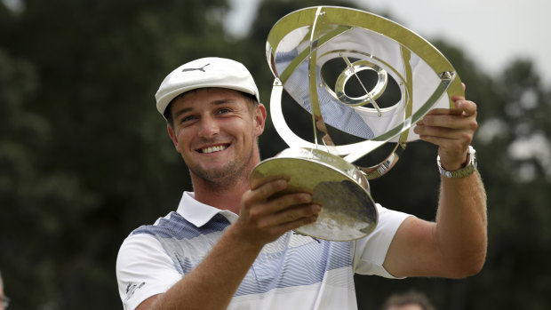 Dominant: Bryson DeChambeau holds up the trophy after winning the Northern Trust golf tournament.