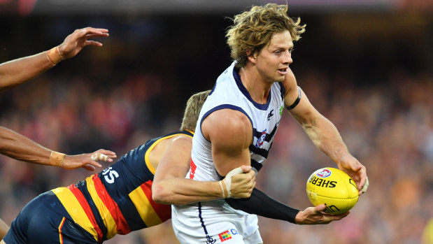 Block and tackle: Hugh Greenwood gets to grips with Fremantle captain Nat Fyfe.