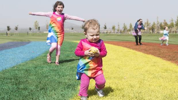 Sophia, 6 and Aurelia Gibbons, 1 of Palmerston play on the giant rainbow.
