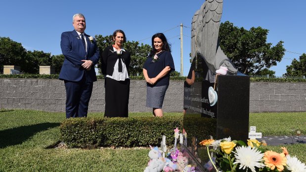 Graham Boyd (left) the CEO of the Southern Metropolitan Cemeteries Trust,  Professor Marie-Paule Austin from the Royal Hospital for Women and Filomena D'Alessandro at the grave of baby Lily Grace.