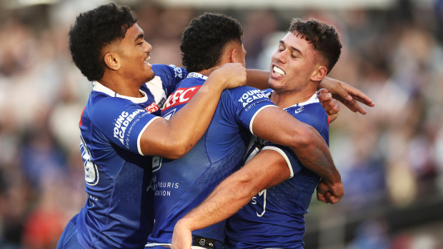 Jake Averillo celebrates one of his two long-range tries with Bulldogs teammates.