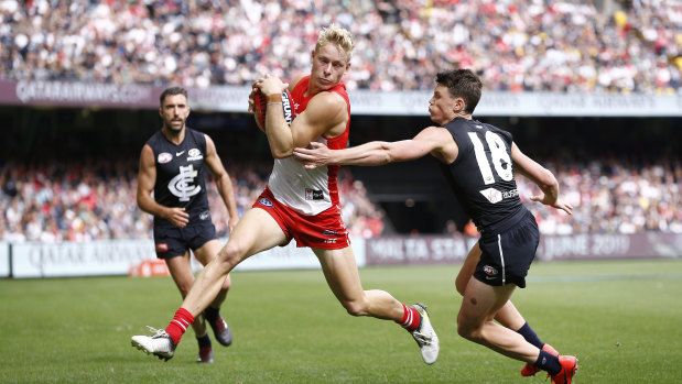 Touching distance: Isaac Heeney evades a tackle during the Swans narrow win over the Blues at Marvel Stadium.