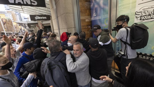 A crowd mobs a police officer during Sydney’s anti-lockdown protests on Saturday. 