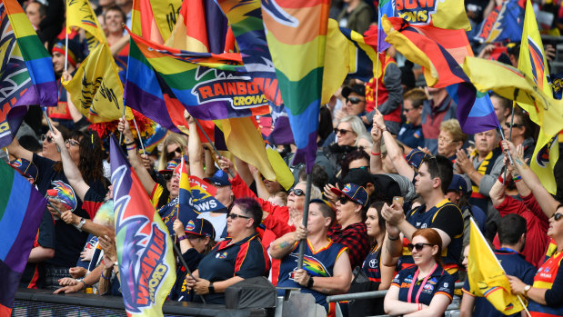 Loud and proud: Adelaide supporters fly the flag during the AFLW grand final between the Crows and the Blues at Adelaide Oval.