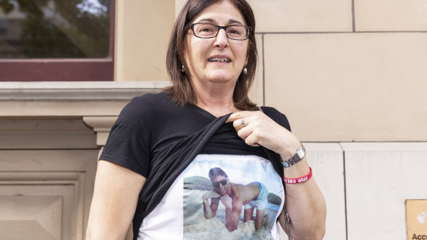 Outside court on Wednesday, Caterina Politi, the mother of one-punch victim David Cassai, displays a T-shirt in his honour.