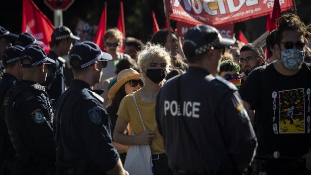 Police watch on at the deaths in custody rally on Saturday.