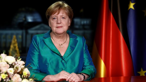 German Chancellor Angela Merkel poses for media after the recording of her annual New Year's speech at the Chancellery in Berlin.