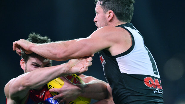 No you don't: Demons co-captain Jack Viney takes Power skipper Travis Boak head-on at Adelaide Oval.