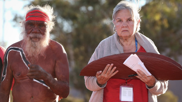 Mutitjulu elder Rolley Mintuma and Pat Anderson from the Referendum Council with a piti holding the <i>Uluru Statement from the Heart</i> last year. The Turnbull government rejected the statement's call for self-determination.
