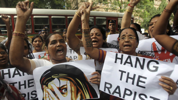 Indian activists hold placards demanding rapists be hanged.