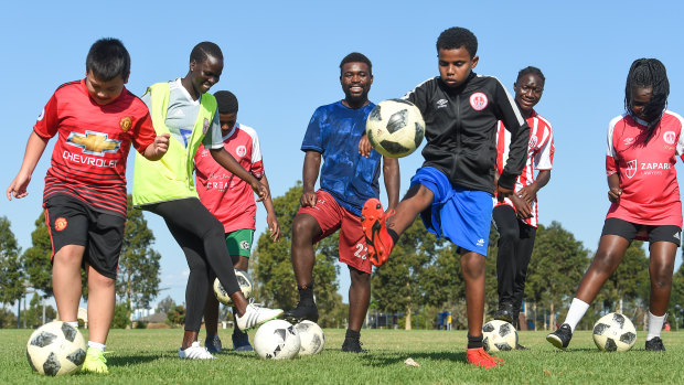 Eangano Singehebhuye teaches children to player soccer in a park in St Albans.
