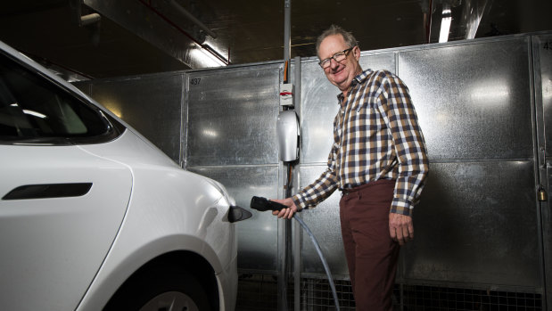 Darryl Bourke, with his Tesla electric vehicle, is happy new charging stations will appear in the ACT and NSW.
