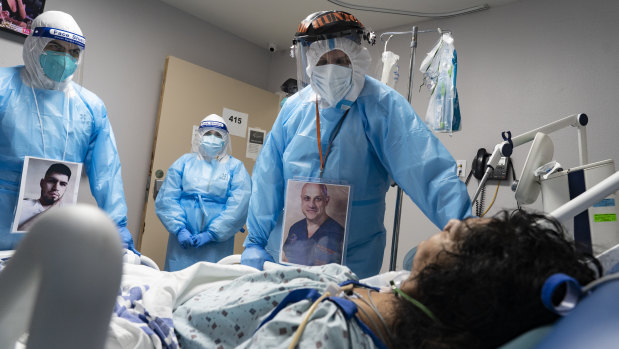 Medical staff wear their photos outside their PPE in COVID ICU at a hospital in Texas.  