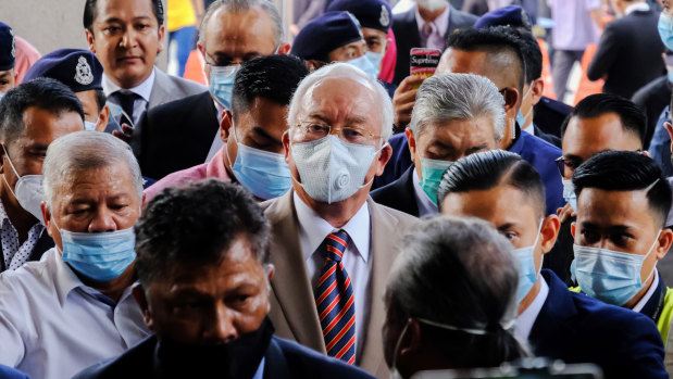 Najib Razak, Malaysia's former prime minister, centre, arrives at the Kuala Lumpur Courts Complex in Kuala Lumpur, Malaysia, on Tuesday.