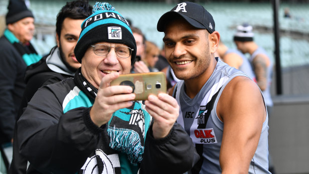 That Power's Dom Barry, here with a fan, has a second chance at an AFL career is an inspiration to his cousin, Melbourne hopeful, Dylan Barry. 