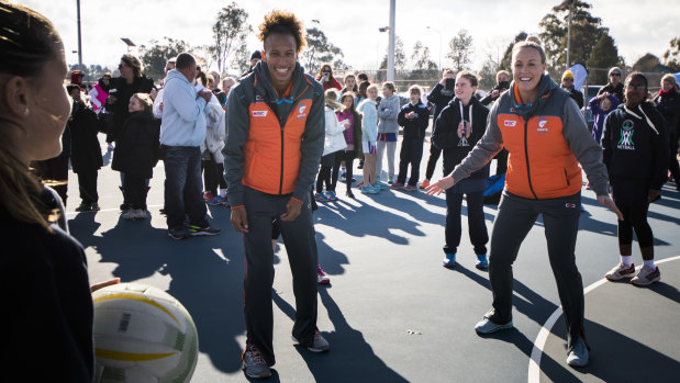 Giants Netball players Serena Guthrie and Kim Green playing around with junior netballers in Canberra on Saturday. 
