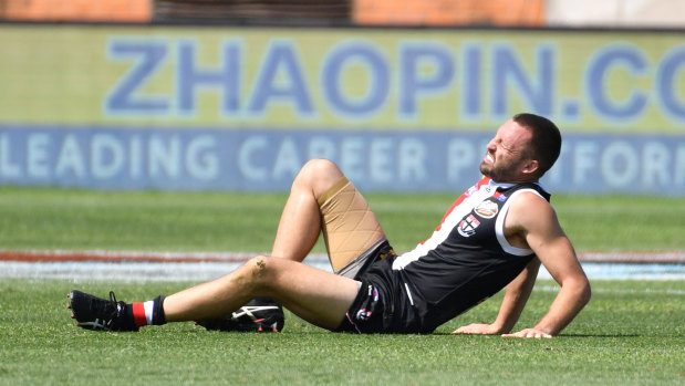 Down and out: St Kilda's Jarryn Geary suffers a serious blow during the match in Shanghai.