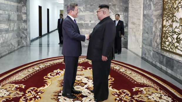 South Korean President Moon Jae-in, left, and North Korean leader Kim Jong-un shake hands before their meeting at the northern side of the Panmunjom in North Korea on May 26.