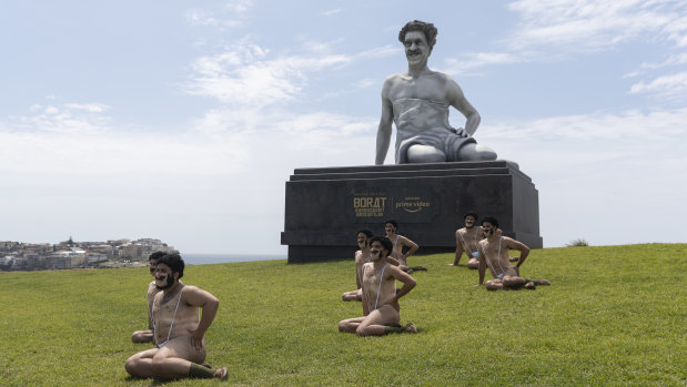 Impersonators pose with a six-metre statue of Borat at Bondi's Marks Park.