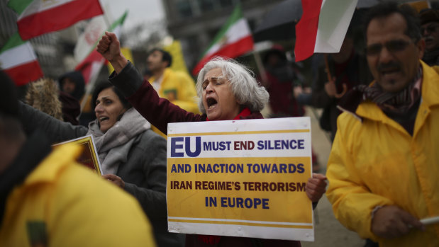 Activists of the National Council of Resistance of Iran shout slogans outside the European Council headquarters during a EU Foreign Ministers meeting on Friday.