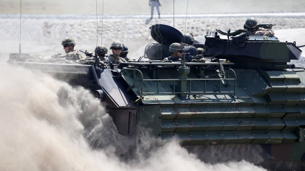 Amphibious Assault Vehicles, AAVs, carry American and Philippine troops in joint exercises in April.