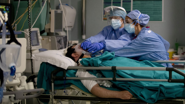 Staff tend to a patient in the emergency COVID-19 ward at the San Carlo Hospital in Milan, Italy.