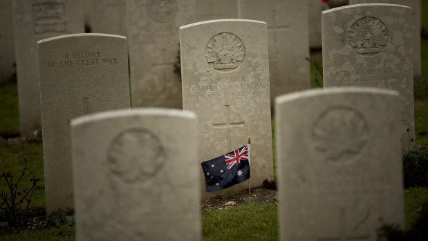 An Australian flag adorns the headstone of an unknown soldier at the World War I Australian National Memorial in Villers-Bretonneux, France.