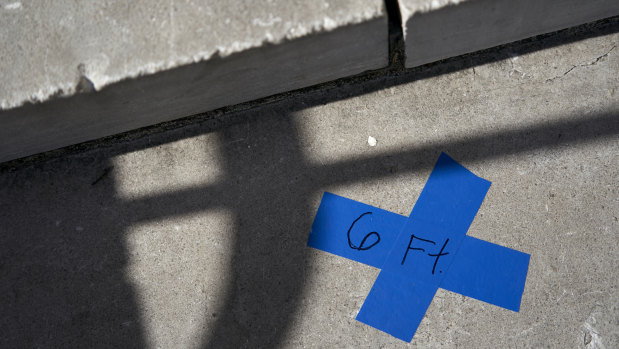A social distancing marker is displayed on the ground during a technology deployment event at Mockingbird Elementary School in Dallas, Texas.