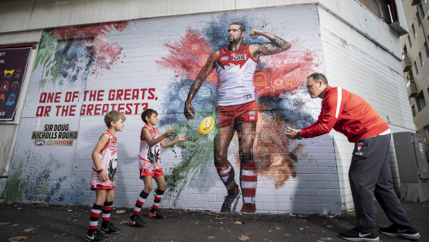 Proud: John Longmire joins Swans fans Dillon and Joel ahead of the AFL's Indigenous round.