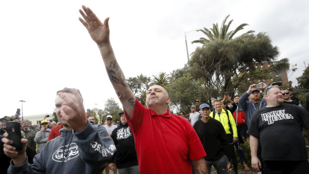 A protester issues a Nazi salute at Saturday's St Kilda rally.