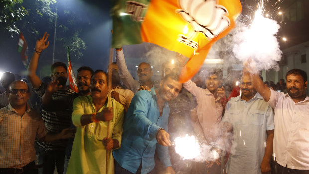 Supporters of India's ruling Bharatiya Janata Party (BJP) light firecrackers and celebrate the government revoking Kashmir's special status in Lucknow, India.