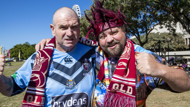 New South Wales Blues fan Steve O'Donoghue and Queensland Maroons fan Bazza Harwood posing for a portrait at South Bank ahead of game one of State of Origin.